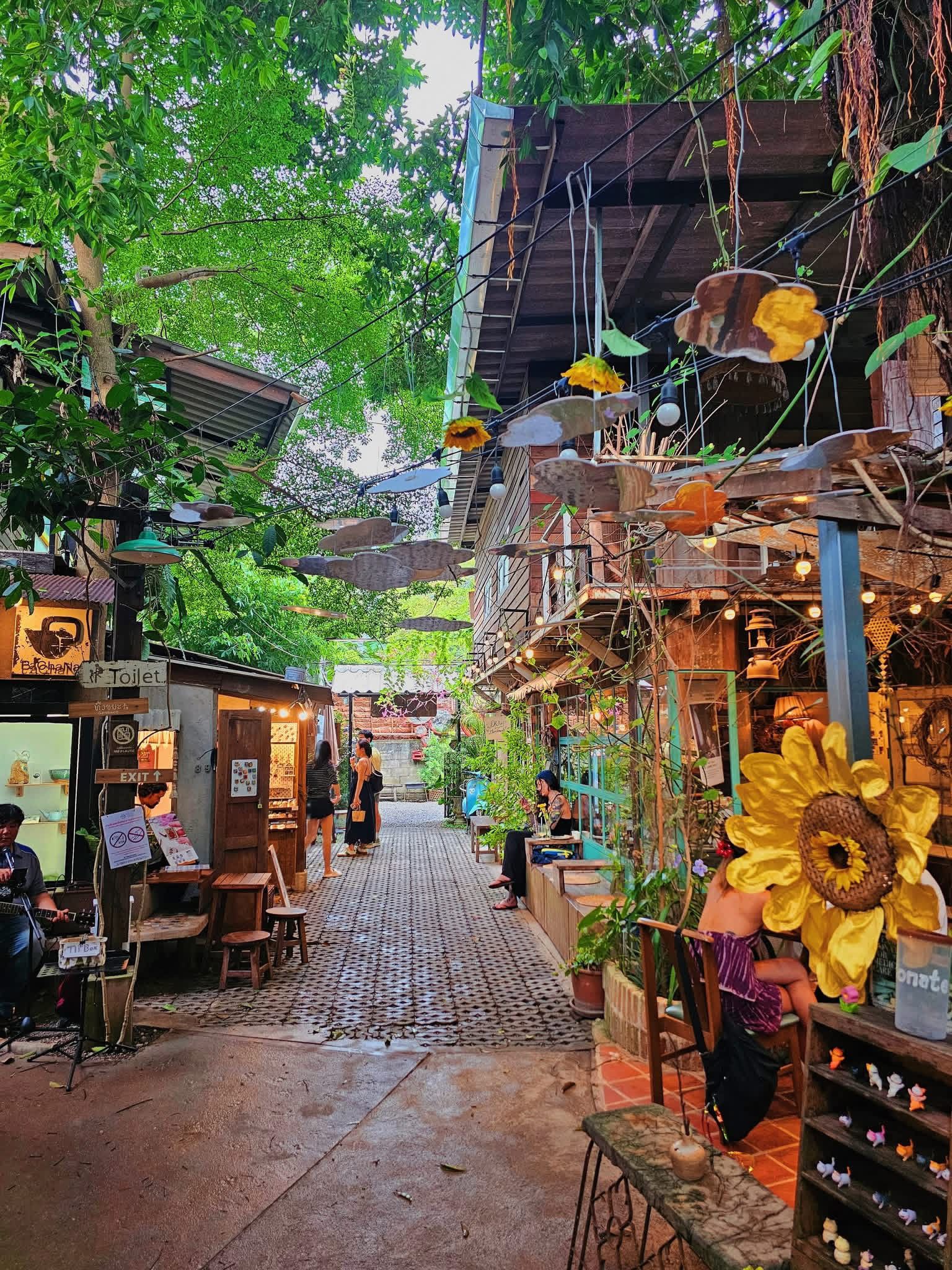 Sunflower-decorated wooden artisan studio at Baan Kang Wat