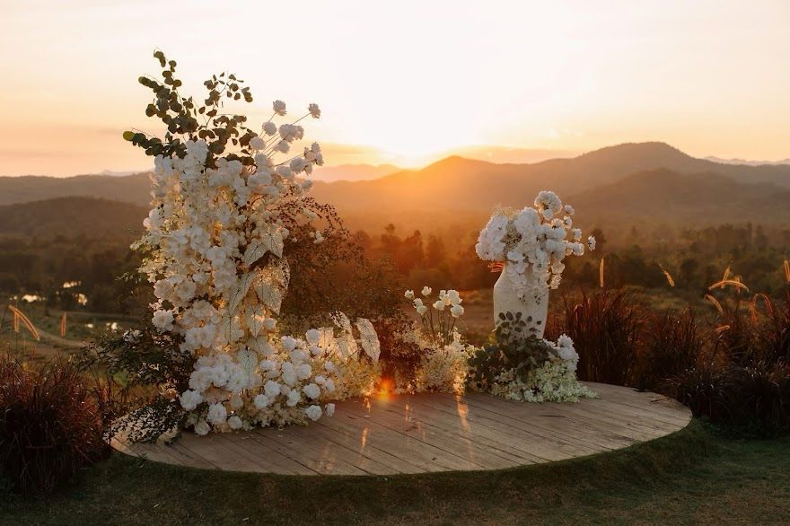 Floral ceremony arch on the circular stage at golden hour